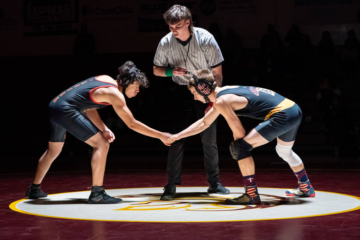 Pahrump Valley High School senior Jacob McLaughlin shakes hands with his opponent Antonio Moren ...