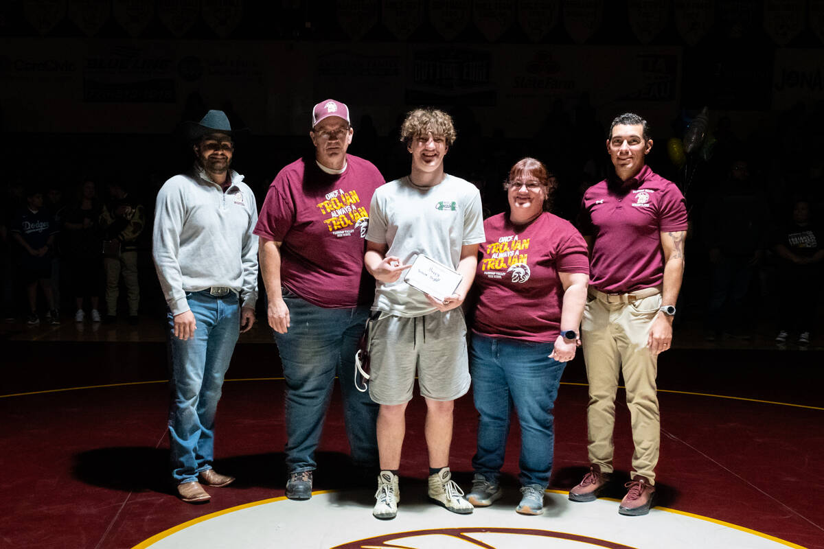 Pahrump Valley High School senior Jacob Stepp is honored with family and wrestling coaches Anto ...