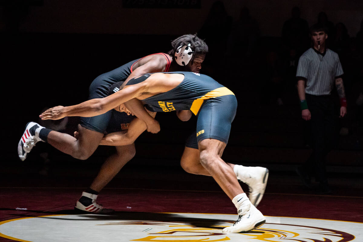 Pahrump Valley High School junior Iyan Bosket attempts to shoot a takedown at his opponent Marl ...