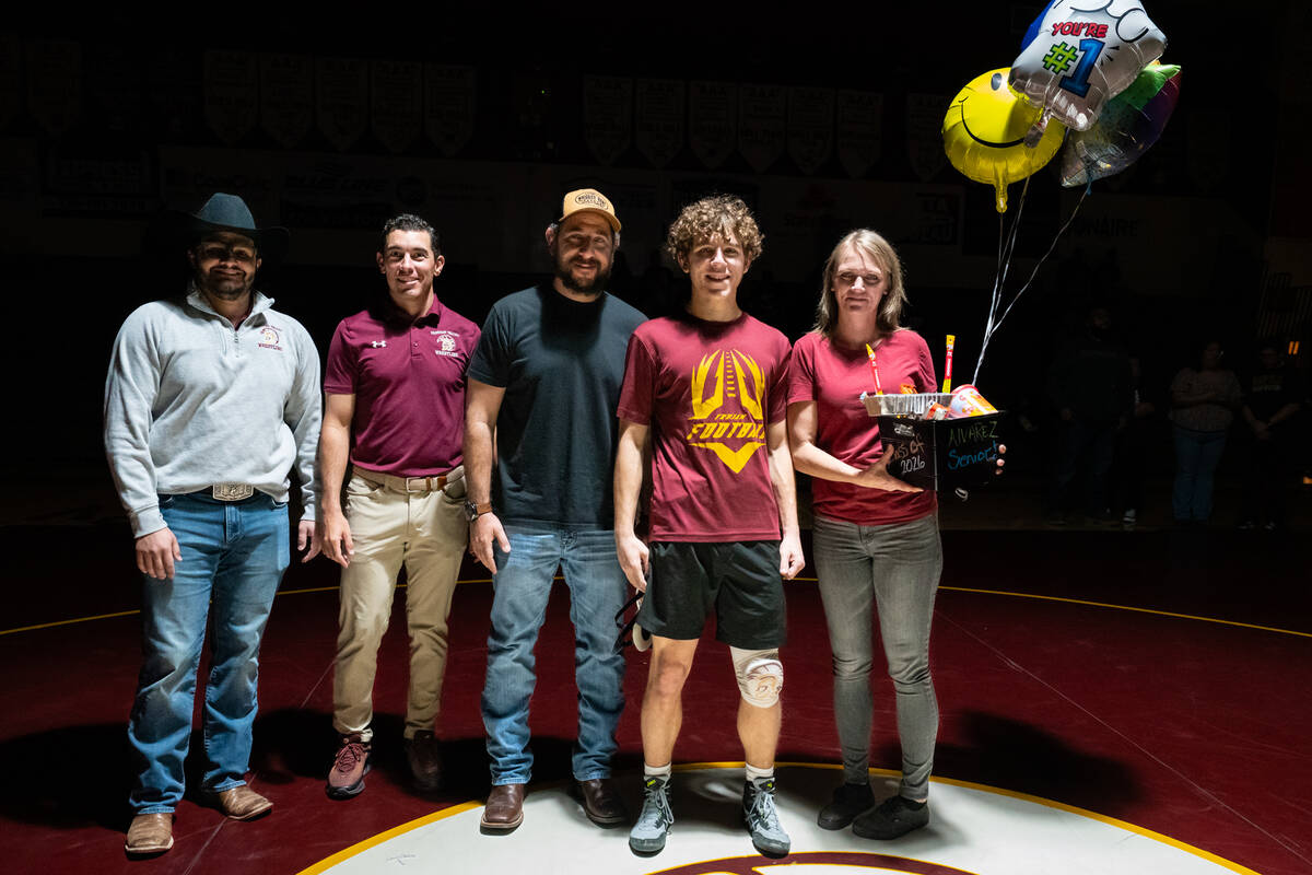 Pahrump Valley High School senior Austin Alvarez is honored on senior night alongside family an ...