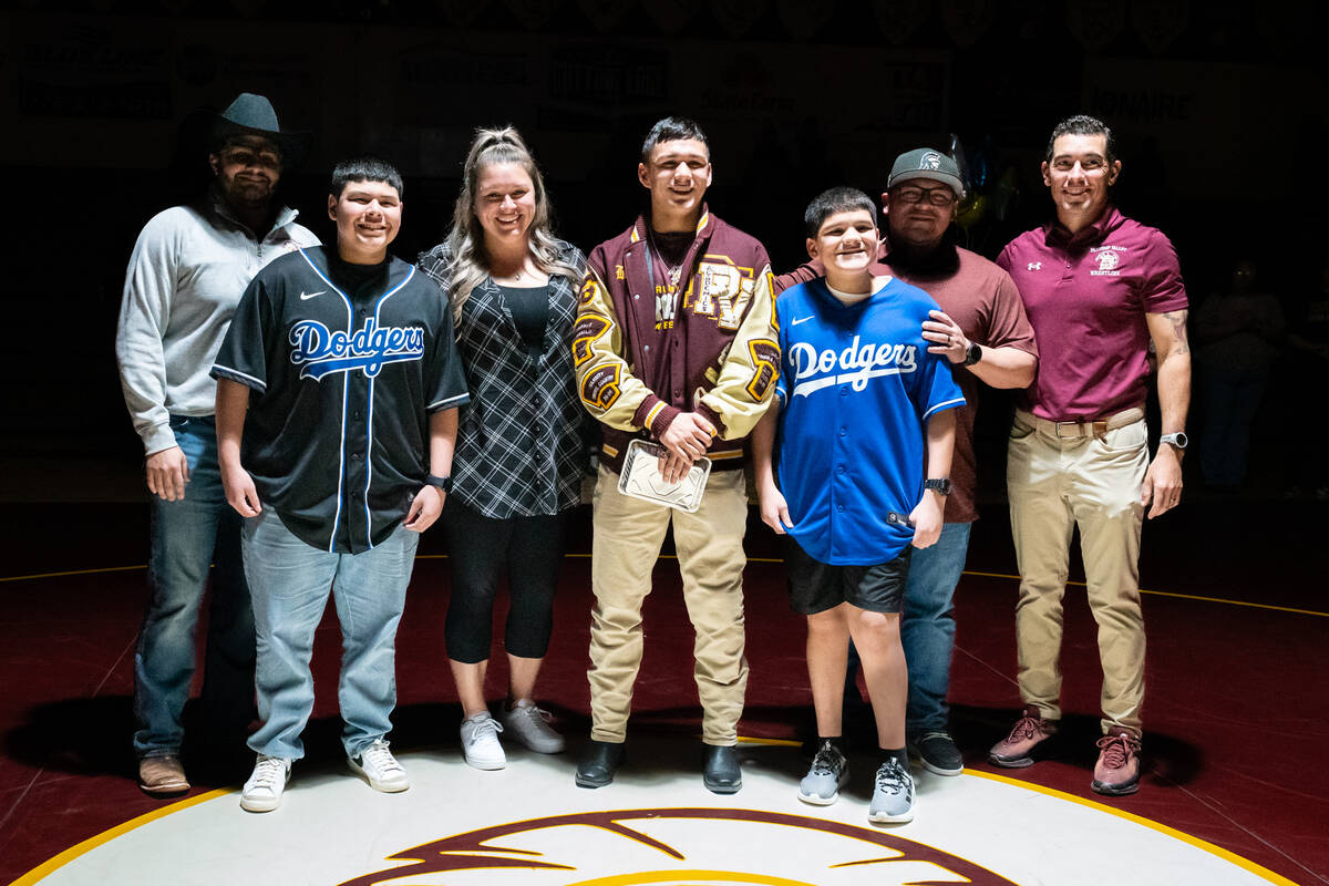 Pahrump Valley High School senior Benjamin De Santiago is honored on senior night alongside fam ...