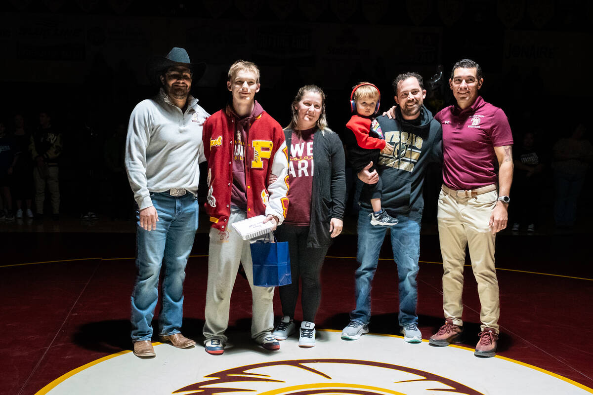 Pahrump Valley High School senior Jacob McLaughlin is honored during senior night with family a ...