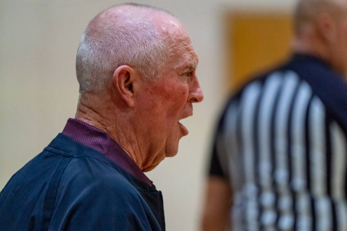 Pahrump Valley High School varsity girls basketball head coach Bob Hopkins tries to grab the at ...