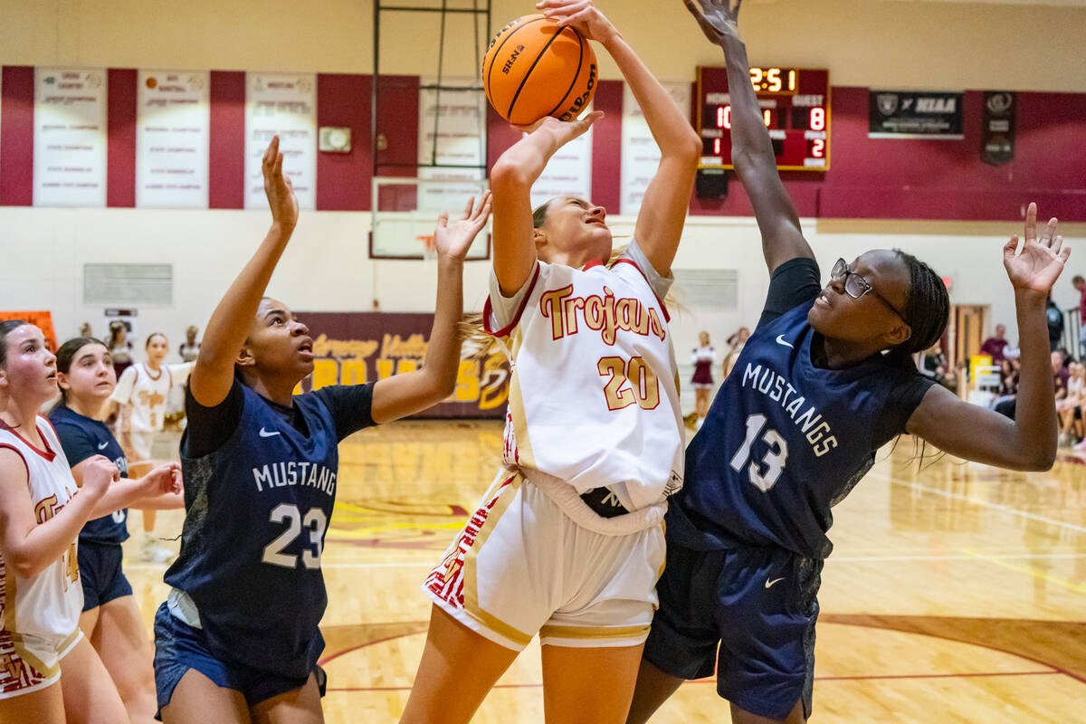 Pahrump Valley High School varsity girls basketball junior Riley Saldana pushes past The Meadow ...