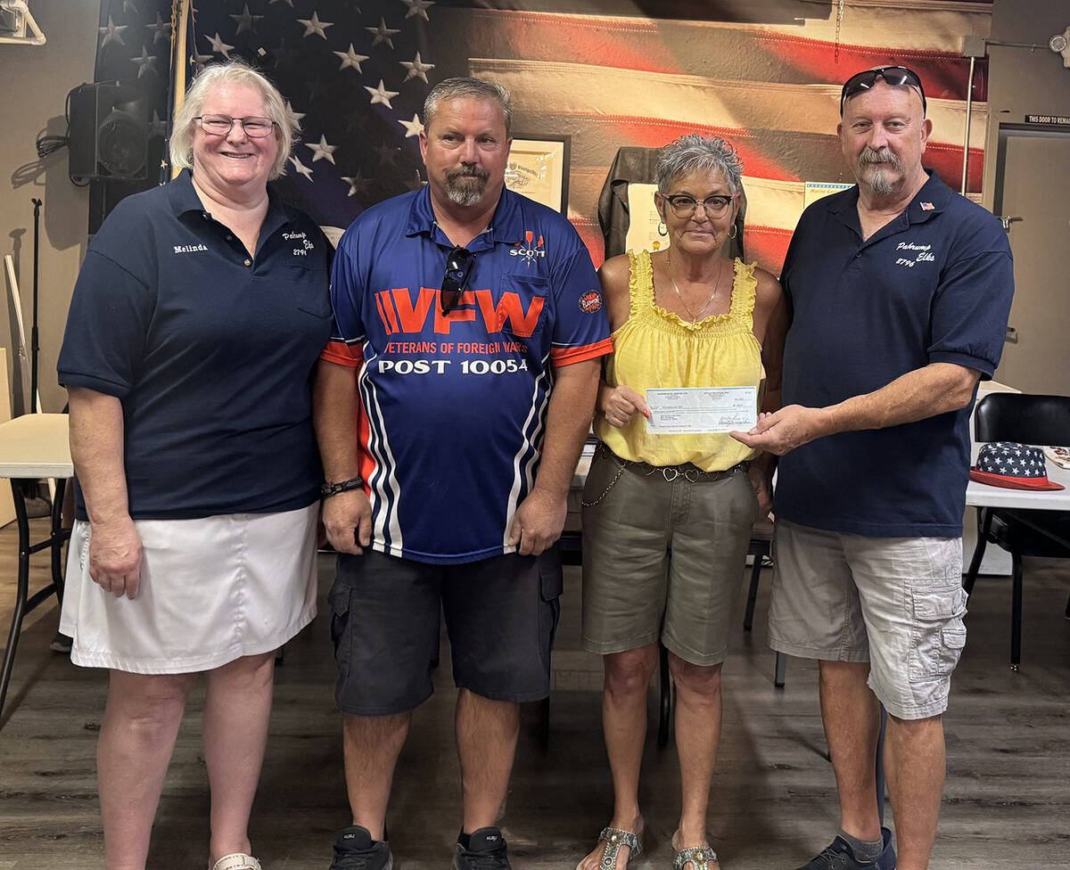 Elks members Melinda Mills, left, and Pete Kurylowicz, right, present a donation check for $1,0 ...