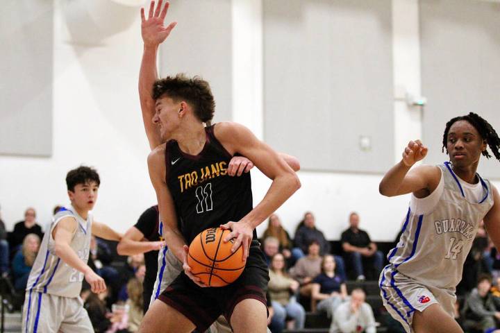 Pahrump Valley High School center Aydon Veloz is met with hard contact in the paint against GV ...