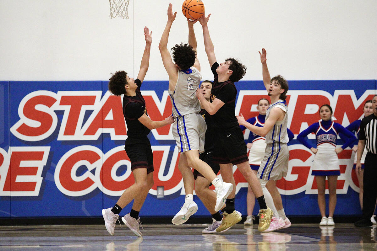 Pahrump Valley High School's Trae Plein and Caden Briscoe attempt to get a block on GV Christia ...