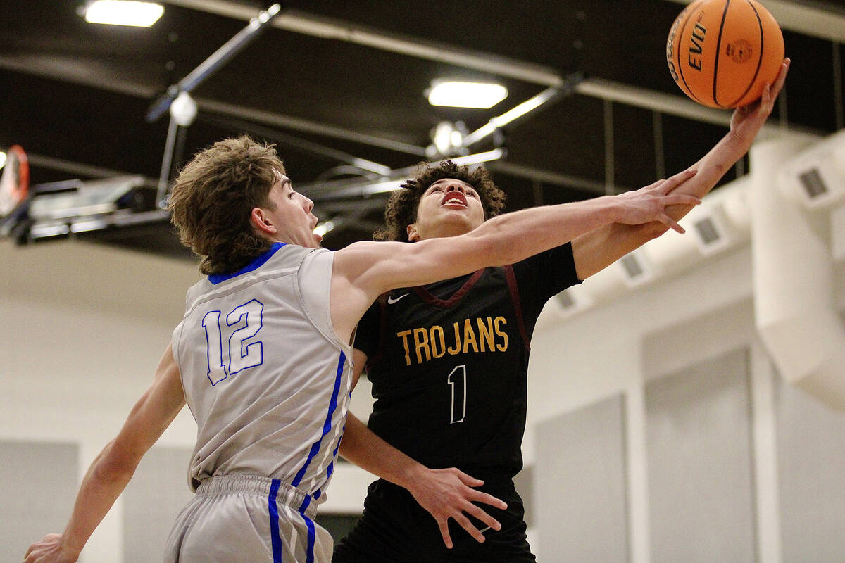 Pahrump Valley High School junior Trae Plein drives in for a layup against GV Christian sophomo ...