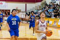 Pahrump Valley High School senior Aydon Veloz drives in for the layup against Cristo Rey St. Vi ...