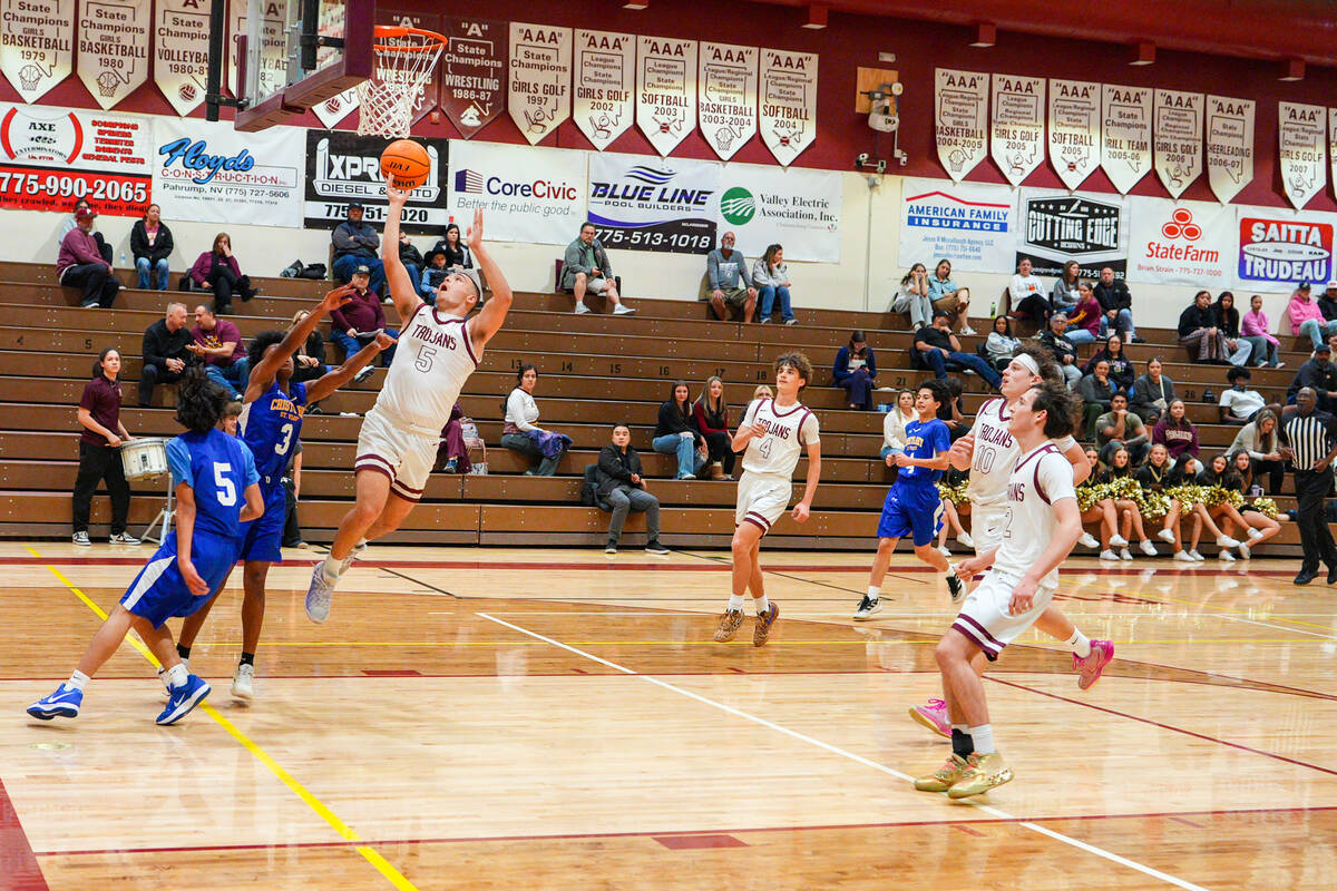 Pahrump Valley High School senior Joshua Slusher converts on a breakaway layup opportunity agai ...