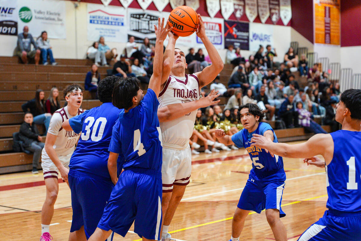 Pahrump Valley High School senior Joshua Slusher flies in hard through the paint on his was for ...