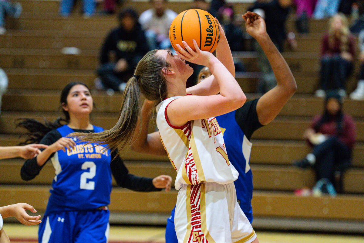 Pahrump Valley High School sophomore Kaitlyn Brown looks to find a basket opportunity underneat ...