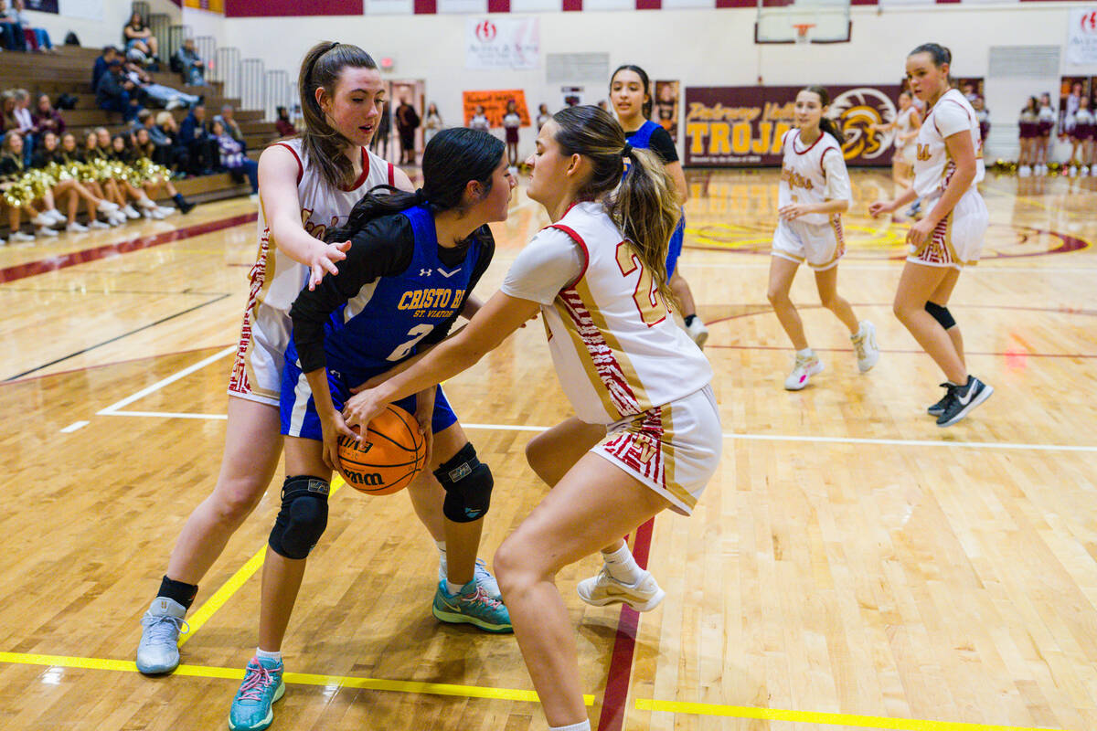 Pahrump Valley High School's Riley Saldana and Kaitlyn Brown wrestle for possession of the ball ...