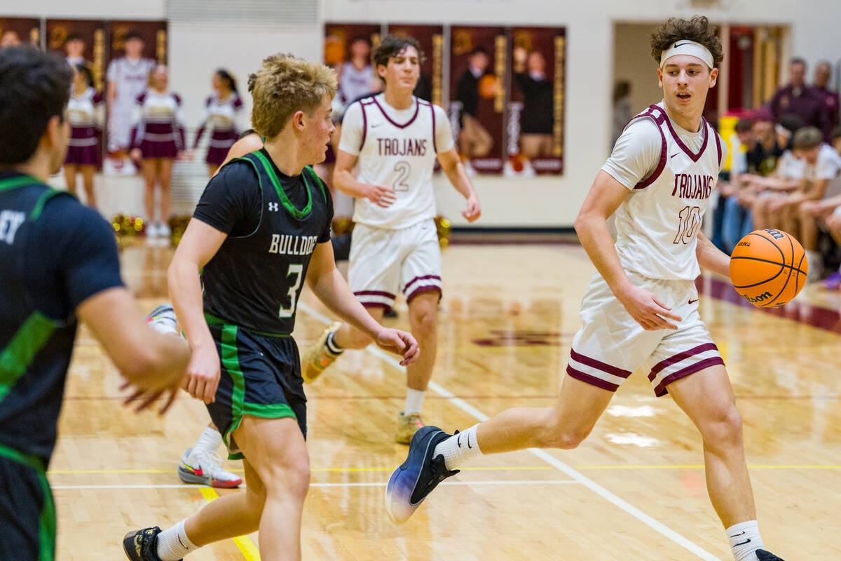 Pahrump Valley High School junior Lucas Gavenda sizes up the Bulldogs defense during the Trojan ...