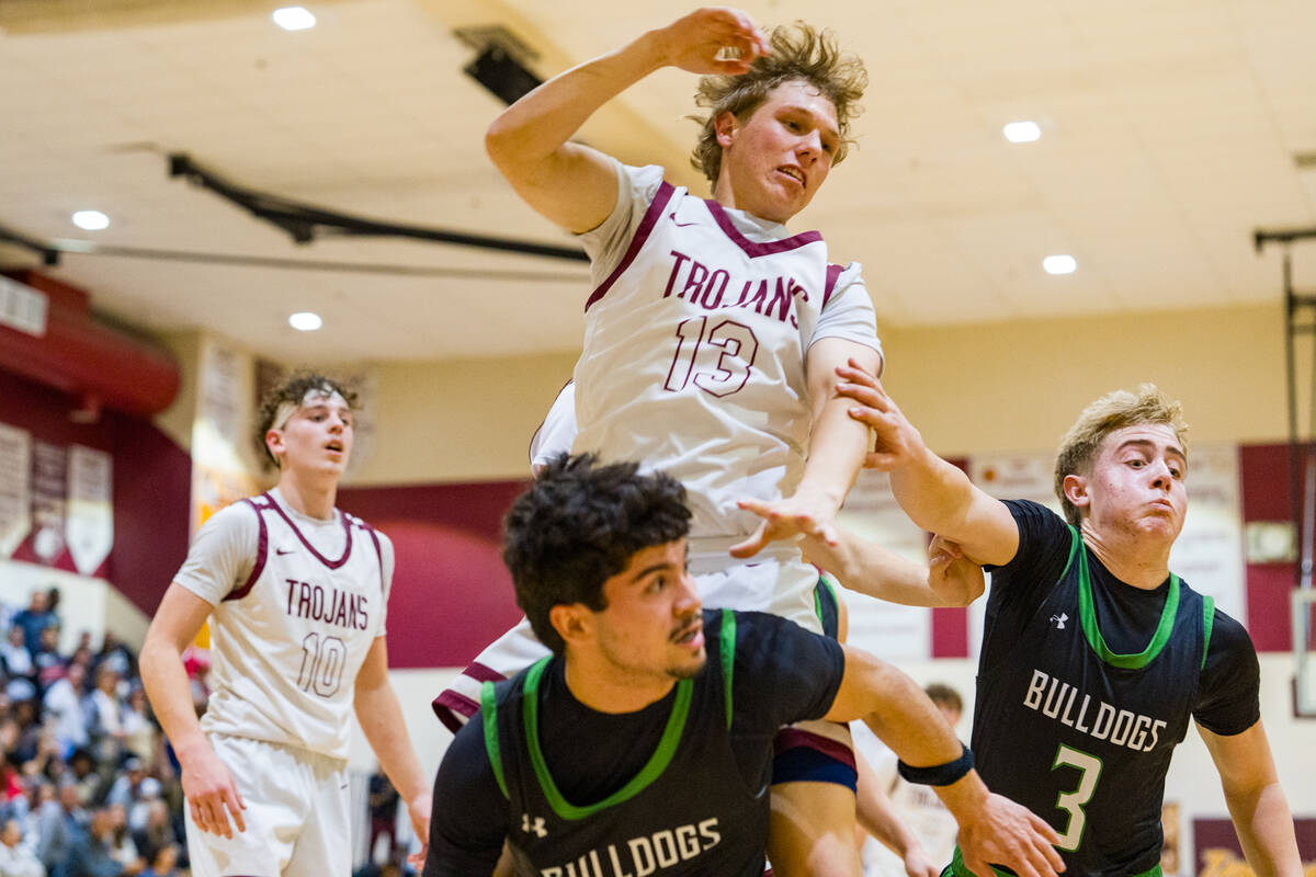 Pahrump Valley High School junior TC Hone towers over a Virgin Valley High School defender duri ...