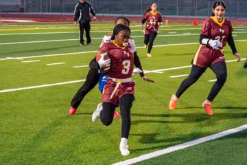 Pahrump Valley High School flag football's Ma'liyah Collins evades a defender during the Trojan ...