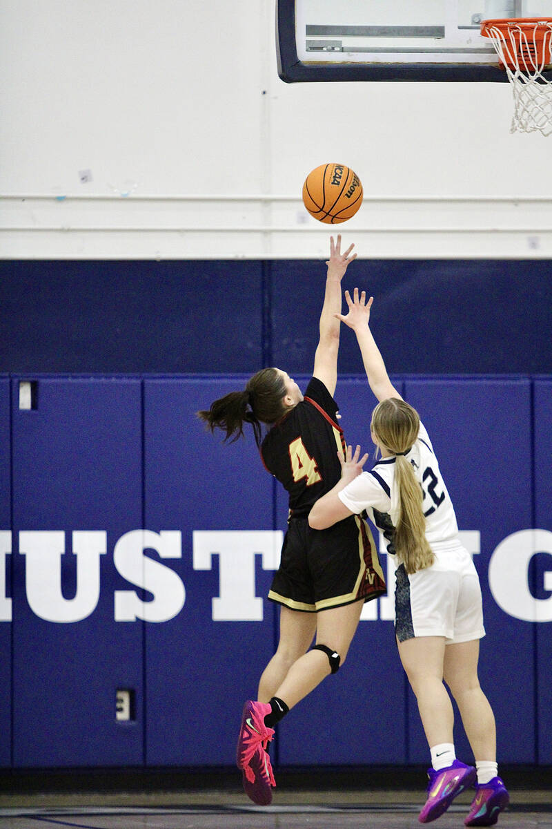 Pahrump Valley High School sophomore Aurora Bowers lets a layup fly against a one-on-one drive ...