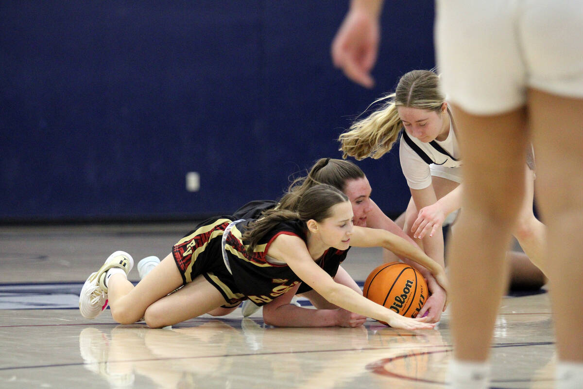 Pahrump Valley High School sophomores Kaitlyn Brown and Addi Nelsen fight for possession of the ...
