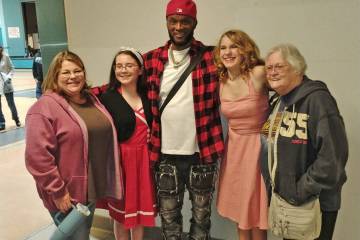 Wild Bill Young poses with local teens Malia Miller, second from left, and Avery Sampson, secon ...