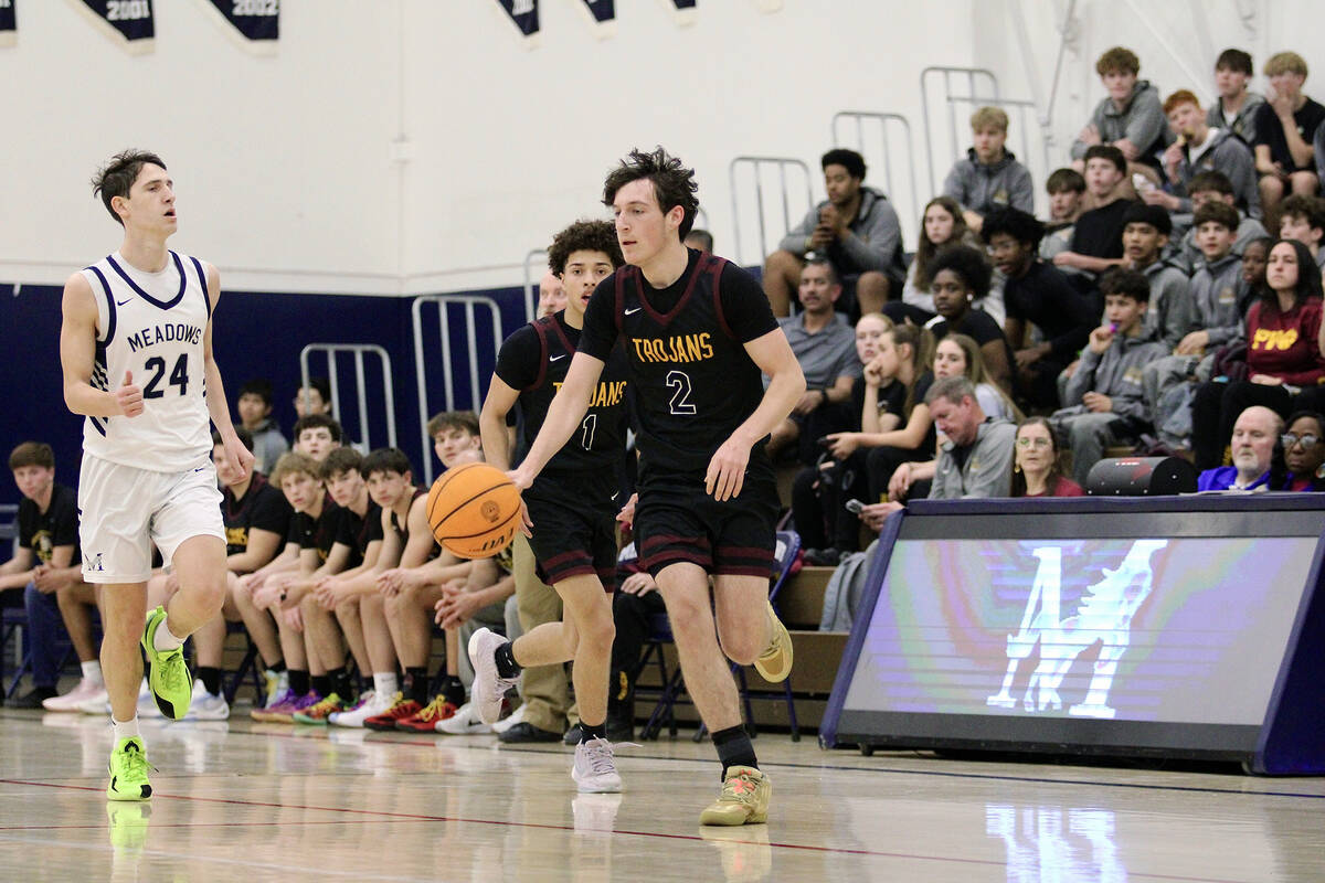 Pahrump Valley High School senior Caden Briscoe advances the ball up the court in a road league ...