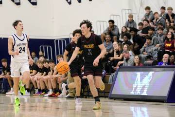 Pahrump Valley High School senior Caden Briscoe advances the ball up the court in a road league ...