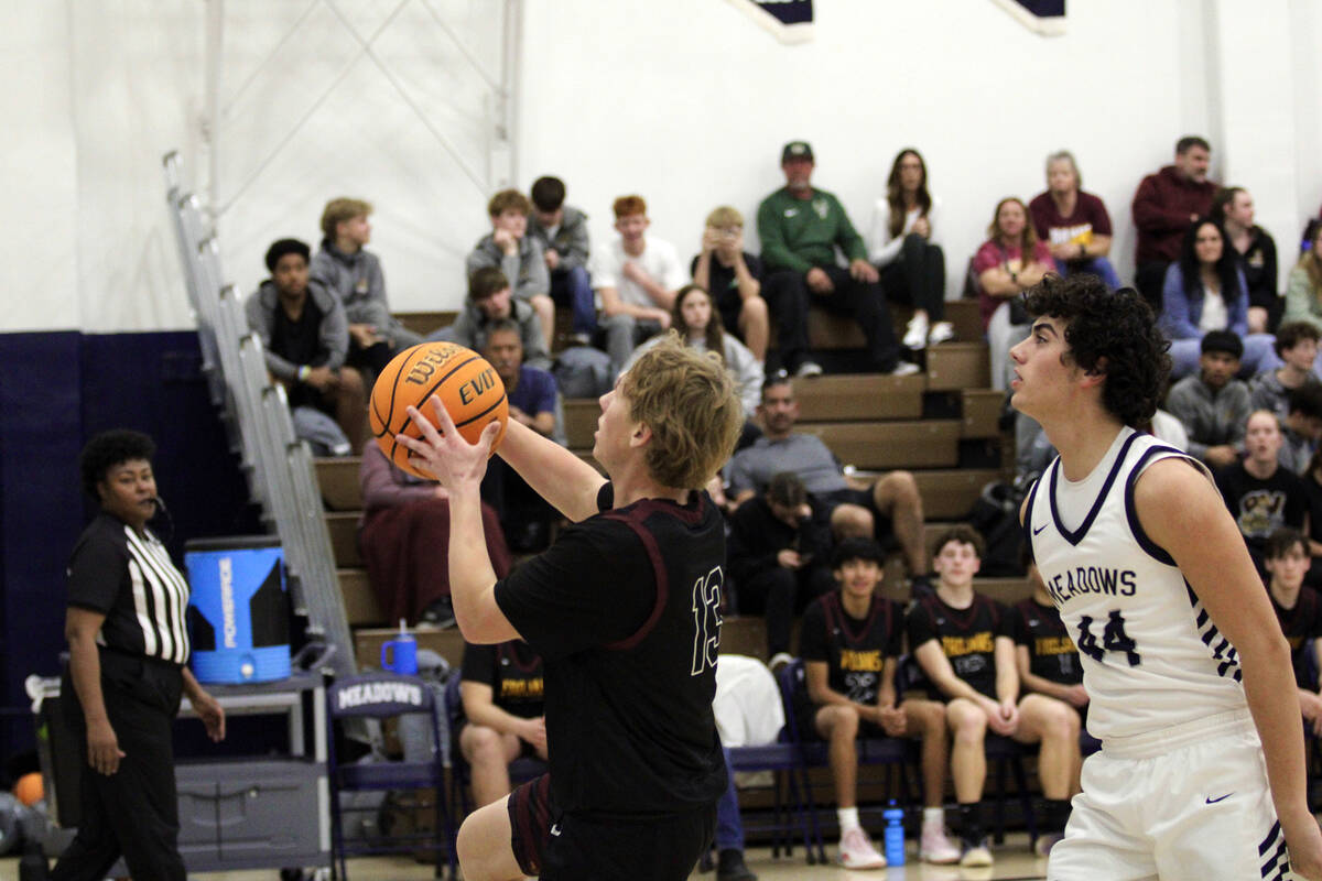 Pahrump Valley High School junior TC Hone flies past a Mustang defender during the Trojans road ...