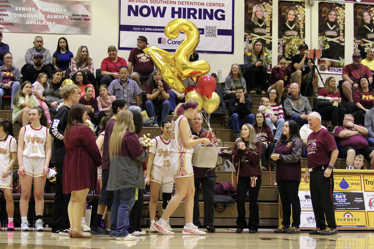 Pahrump Valley High School girls basketball senior Julie Briggs is honored with her friends and ...