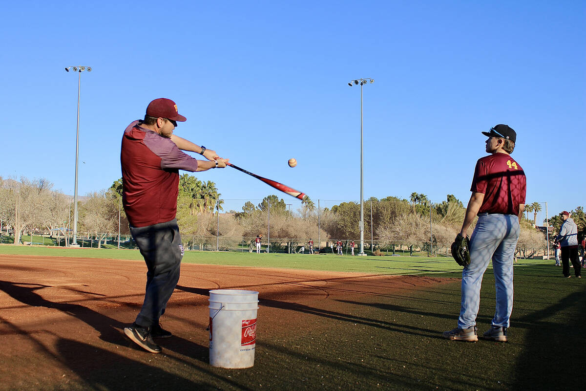 Pahrump Valley High School varsity head coach Drew Middleton hits a fly ball to the Trojans bef ...