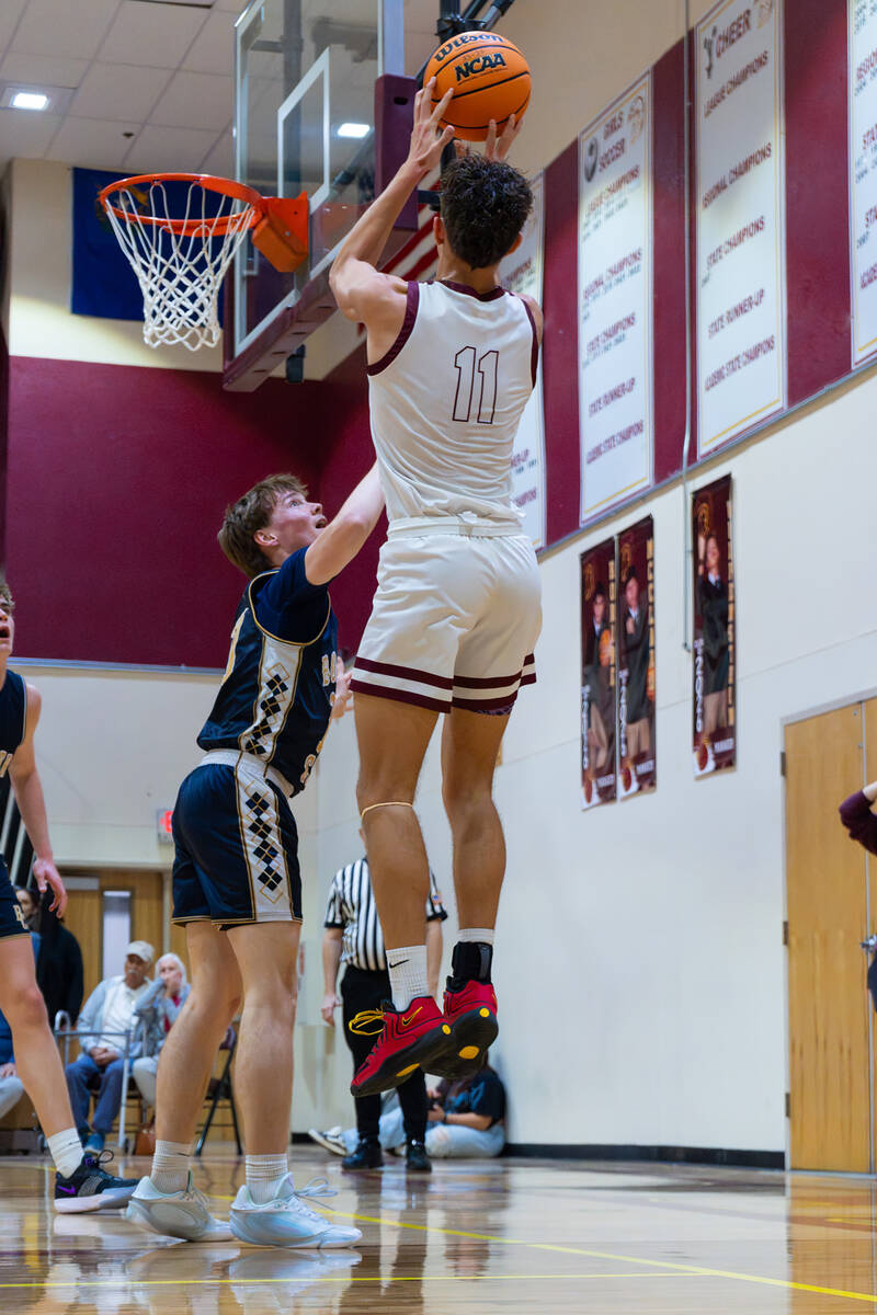 Pahrump Valley High School senior Aydon Veloz pulls up for a jumper in the Trojans' last home g ...