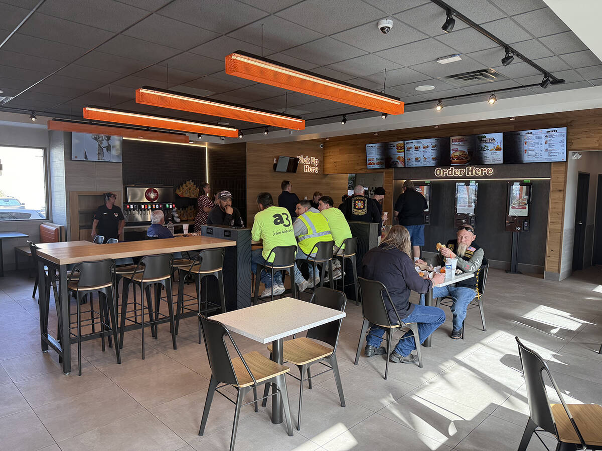 Guests enjoy Burger King's food inside the new dining room during the grand reopening on Friday ...