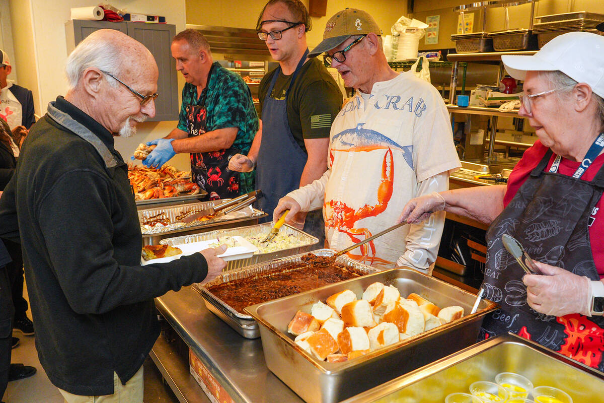 The buffet line at Crab Fest saw steady action as the more than 200 guests grabbed their plates ...