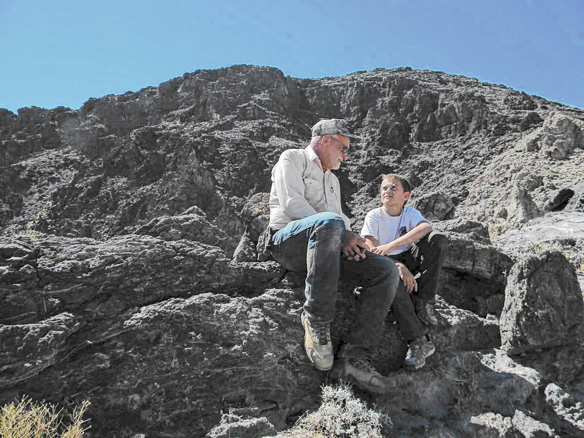 Eddie Pribble and James Reddick take a rest while working at a project to repair and maintain g ...