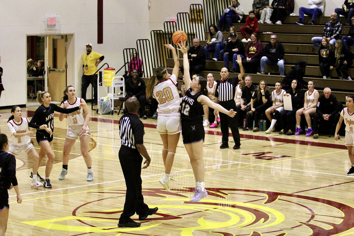 Pahrump Valley High School junior Riley Saldana attempts to win the opening tip-off against Moa ...