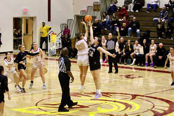 Pahrump Valley High School junior Riley Saldana attempts to win the opening tip-off against Moa ...