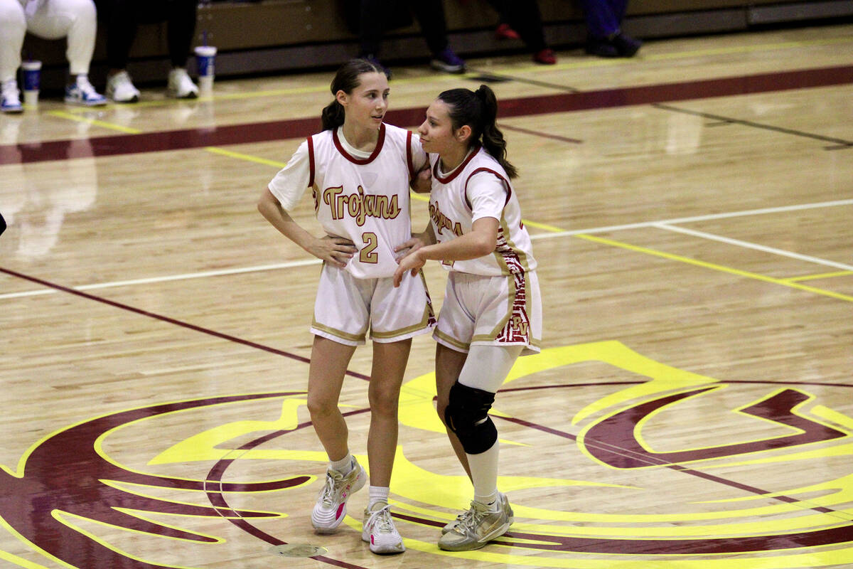 Trojans Addi Nelsen and Autumn Colon share a moment together at halftime during the first round ...