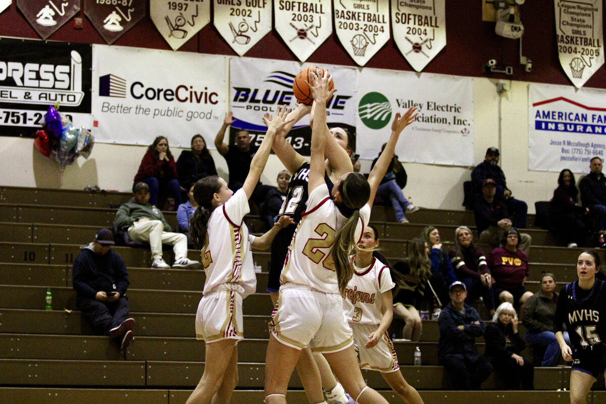 Trojans Riley Saldana and Addi Nelsen play great defense together on Moapa Valley freshman Lily ...