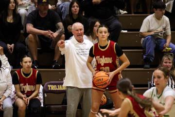 Pahrump Valley High School junior Riley Saldana does her best to locate an open teammate during ...