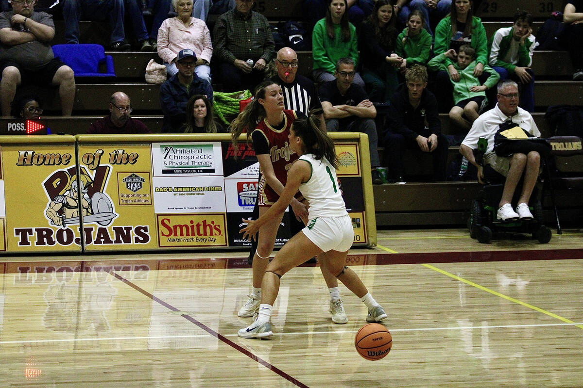 Pahrump Valley High School junior Riley Saldana tries to swing a pass by Virgin Valley sophomor ...