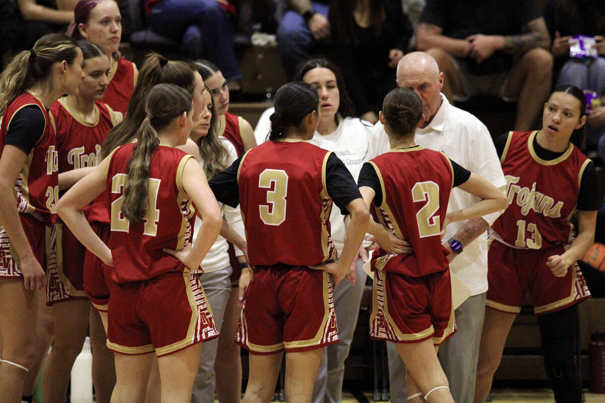 Trojans head coach Bob Hopkins calls for a timeout in the first quarter during the Class 3A reg ...