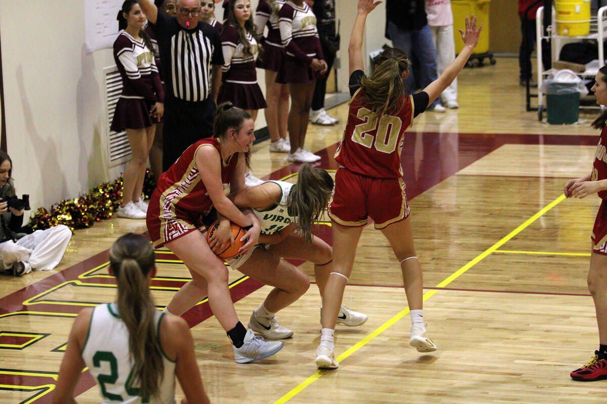 Pahrump Valley High School sophomore Kaitlyn Brown does her best to retain possession of the ba ...