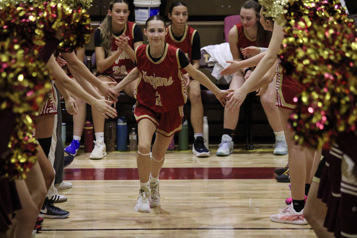 Pahrump Valley High School sophomore Addi Nelsen joyfully runs out of the opening ceremony tunn ...