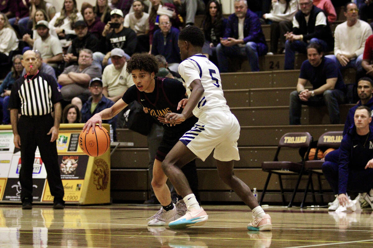 PVHS junior Trae Plein does his best to get by The Meadows freshman Terrance Holmes during the ...