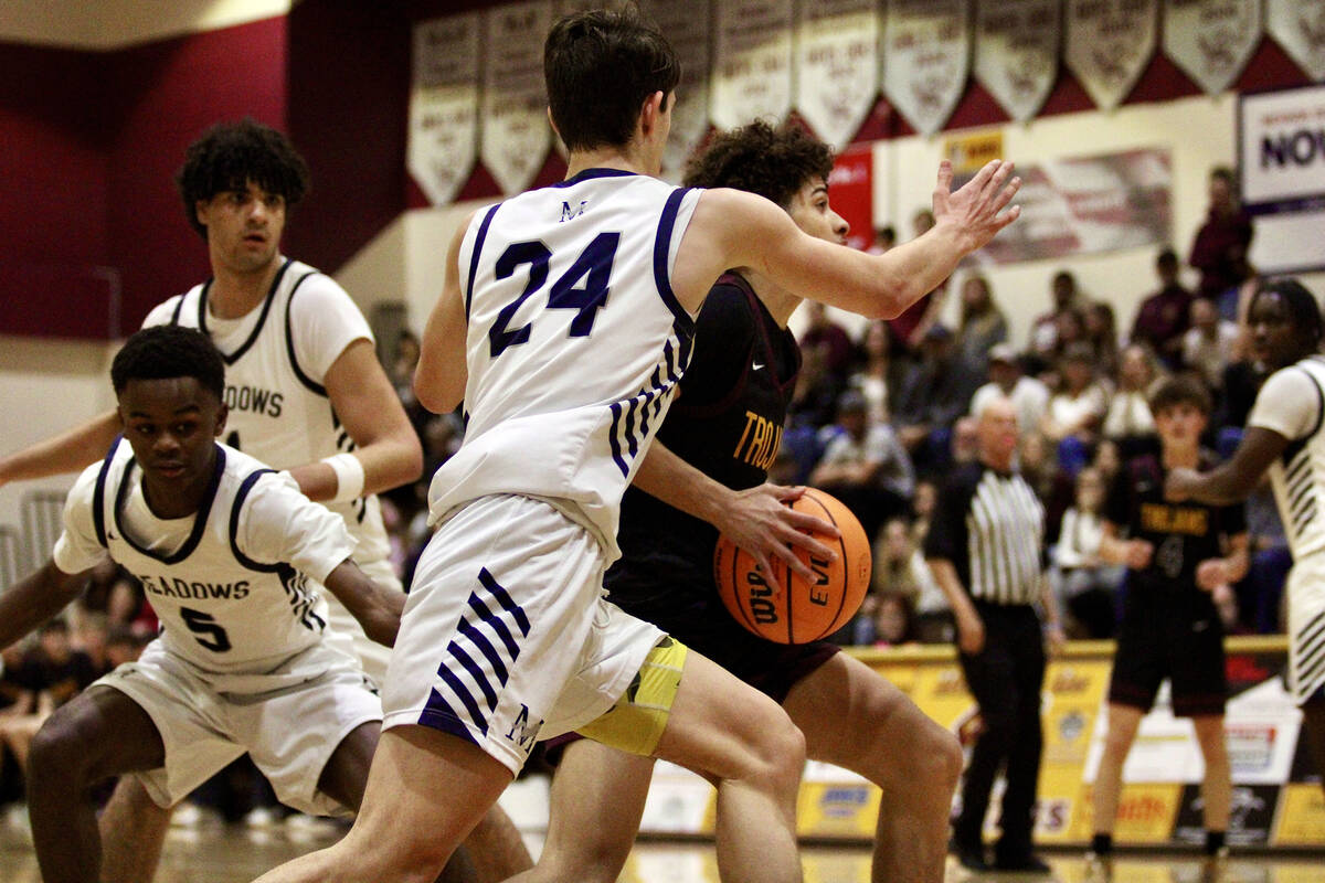 PVHS junior Trae Plein does his best to evade The Meadows senior Grant Moses during the Class 3 ...