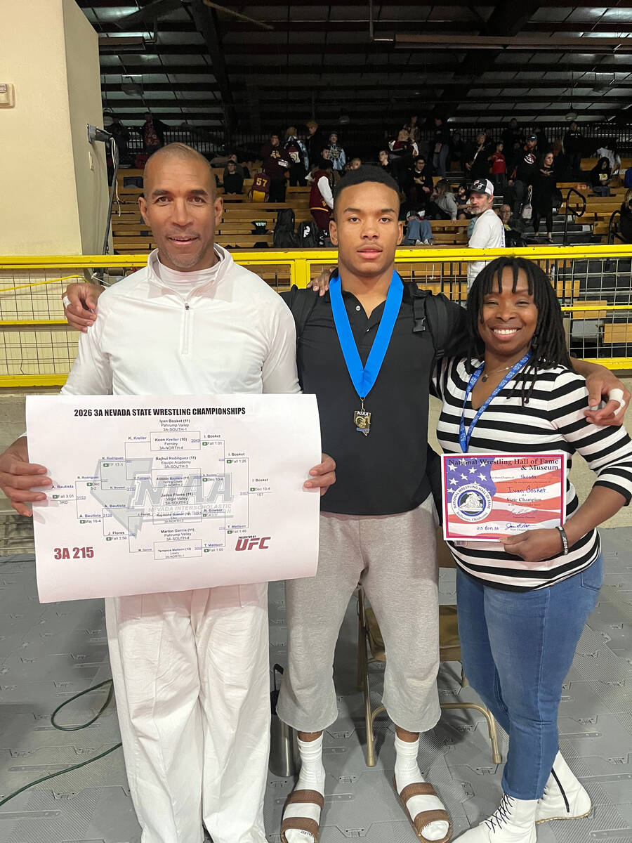 Trojan junior Iyan Bosket celebrates with family following his 1st place finish in the 2026 3A ...