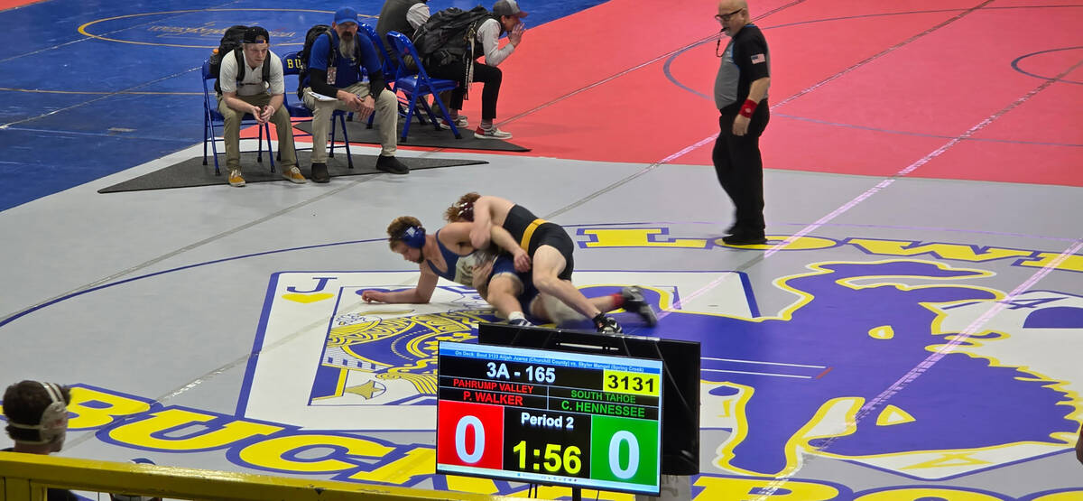 Trojan Paul Walker goes up against his opponent from South Tahoe High School during the Class 3 ...