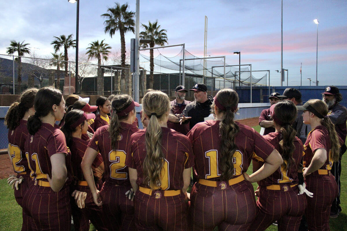 The Pahrump Valley High School varsity softball program gathers around head coach Brian Hayes t ...