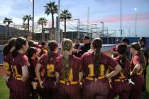 The Pahrump Valley High School varsity softball program gathers around head coach Brian Hayes t ...