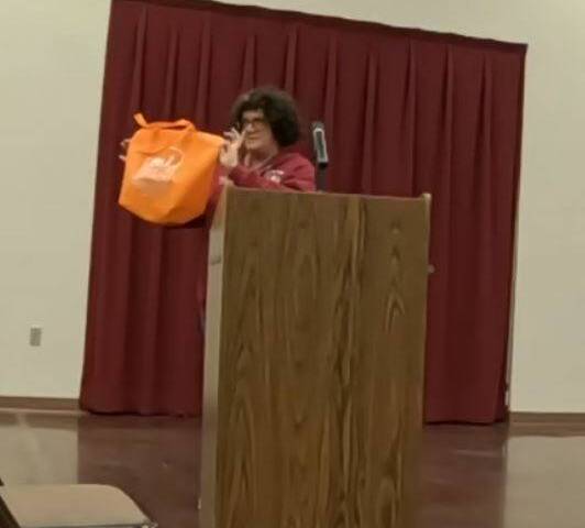 Ginny Faulkner of the Beatty Chamber of Commerce shows Beatty's 'merch' for sale in the town of ...