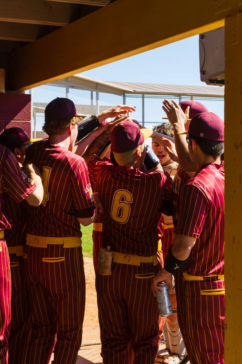 The Pahrump Valley High School varsity baseball team celebrates a run coming across the plate d ...