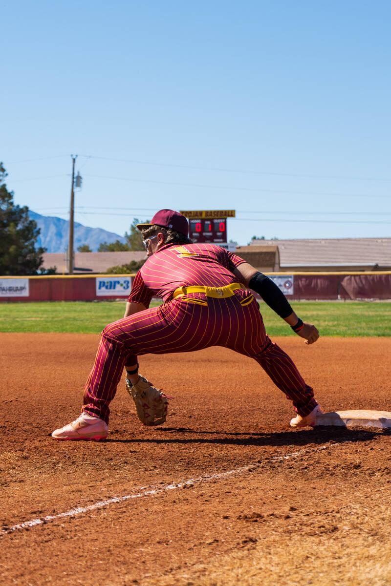 Pahrump Valley High School sophomore CJ Nelson picks a ball out of the dirt during the Trojans' ...